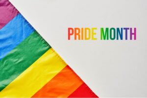 rainbow flag and the words "pride month" written in rainbow text